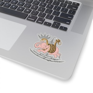 May include: A pink elephant with a golden snake wrapped around it. The elephant is standing on a white background with black text in Thai.