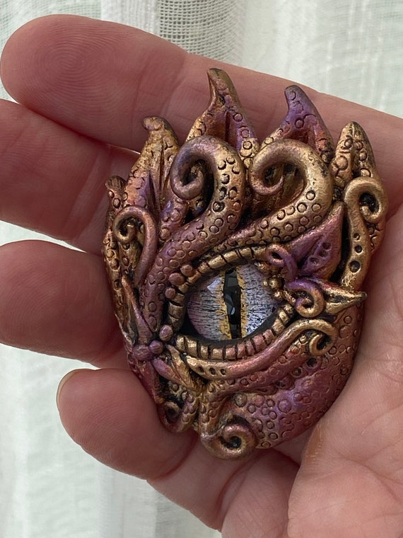 Artist Crafts Fantasy-Inspired Accessories Featuring Realistic Dragon Eyes