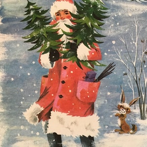 May include: A red-suited figure with a white beard carries a stack of Christmas trees through a snowy landscape. A small brown rabbit watches from the side.