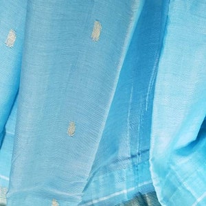 May include: A light blue fabric with a silver border and small silver dots throughout.