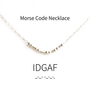 May include: Silver necklace with a Morse code message that reads "IDGAF". The message is spelled out in dots and dashes.