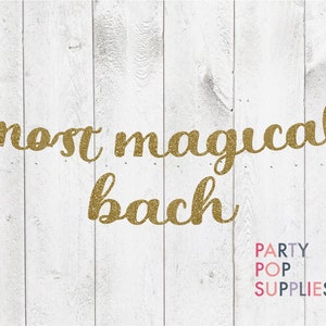 May include: Gold glitter banner that reads "most magical bach" with the words "PARTY POP SUPPLIES" in colorful text below.