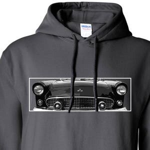 May include: A dark gray hooded sweatshirt with a black and white image of a classic car's front end. The car has a chrome grill and headlights.