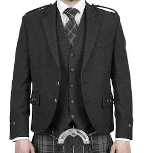 May include: A dark grey kilt jacket with a matching waistcoat and a plaid kilt. The jacket has a single button fastening and a notched lapel. The waistcoat has a button fastening and a pocket on the left side. The kilt is a traditional Scottish kilt with a plaid pattern.