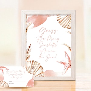May include: A framed sign and accompanying cards with a beach theme. The sign displays the text "Guess How Many Seashells Are in the Jar!" in a stylish script. The design incorporates watercolour seashells, a starfish, and soft pink and beige hues.