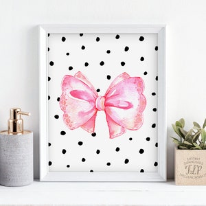 May include: A printable art print featuring a pink watercolor bow on a white background with black polka dots.