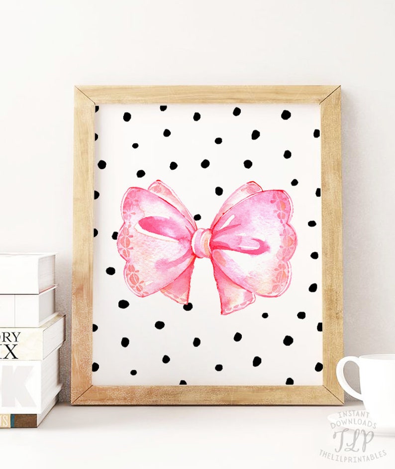 May include: A printable art print featuring a pink watercolor bow on a white background with black polka dots.
