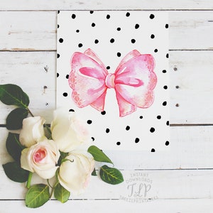 May include: A pink watercolor bow with a white background and black polka dots. The image includes the text "Instant Downloads TLP TheLittlePrintShop".