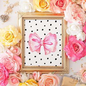 May include: A gold frame with a black and white polka dot background and a pink watercolor bow in the center. The frame is surrounded by pink and yellow flowers.