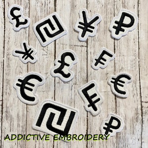 May include: Embroidered patches featuring various currency symbols, including the British pound, Euro, Japanese Yen, and others, in black and white. The patches are on a light wood grain background. The text "ADDICTIVE EMBROIDERY" is at the bottom.