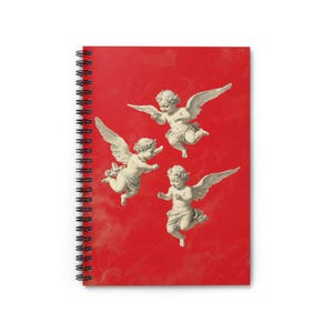 May include: Three cherub angels with wings are flying against a bright red background. The angels are white and have a vintage look.