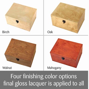 May include: Four wooden boxes in different wood finishes: birch, oak, walnut, and mahogany. Each box has a hinged lid and a black metal latch.  "Four finishing colour options final gloss lacquer is applied to all" text is at the bottom of the image.