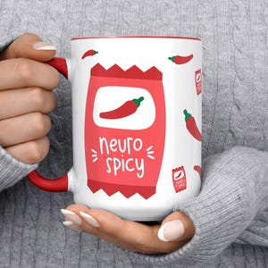 May include: White ceramic mug with a red chili pepper graphic and the text "neuro spicy".