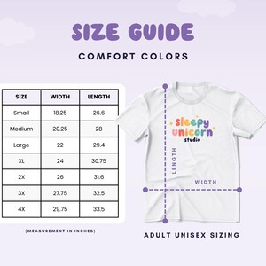 May include: White adult unisex t-shirt with the text "sleepy unicorn studio" in colourful lettering. A size guide shows measurements in inches for sizes small to 4X. The background is a light purple with cloud graphics.