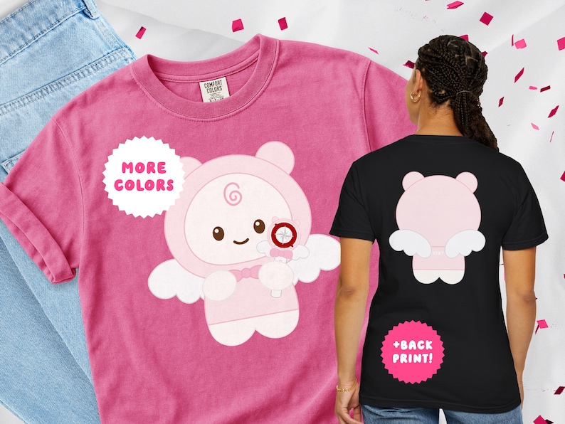 May include: A pink t-shirt featuring a cartoon angel bear design on the front and back. The front of the shirt has the text "MORE COLORS" in a white circle. The back of the shirt has the text "+BACK PRINT!" in a pink circle.