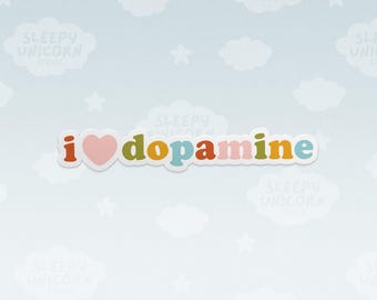 May include: A die-cut sticker featuring the text I heart dopamine in a rounded, colorful font. The letter i is dark orange, the heart is light pink, and the letters d-o-p-a-m-i-n-e are in olive green, yellow, blue, red, pink, olive green, yellow, and blue.