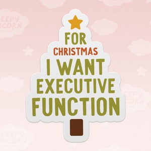 May include: A white Christmas tree sticker with a yellow star on top. The text on the sticker reads "For Christmas I Want Executive Function".