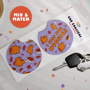 May include: Two car coasters with a purple background and a pattern of chicken nuggets and dipping sauce. One coaster says "I stop for nuggies." The coasters are packaged with a car key and a car-shaped keychain.