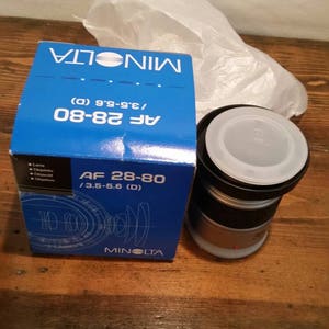 Minolta Maxxum camera lens still in original packaging