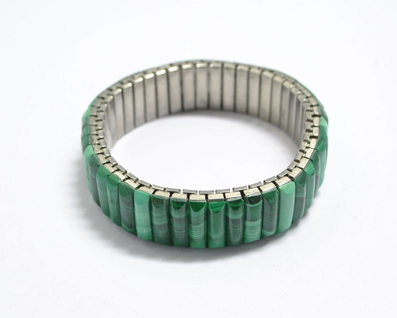 May include: A green malachite stone bracelet with a silver expandable band.
