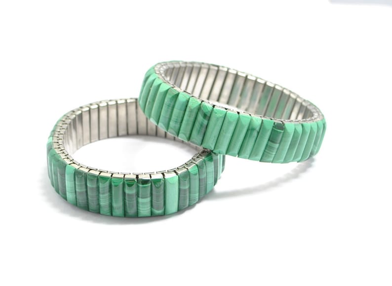 May include: Two green malachite stone bracelets with a silver metal expandable band.