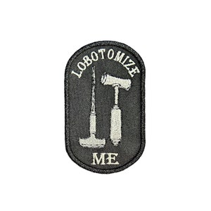 May include: Black embroidered patch with white stitching. The patch features two medical tools, a hammer and a chisel, with the text "lobotomize me" around the tools.