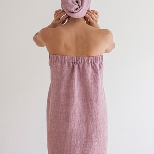 Pu&ograve; includere: Un accappatoio rosa in spugna a nido d'ape con stile avvolgente e cintura con coulisse.