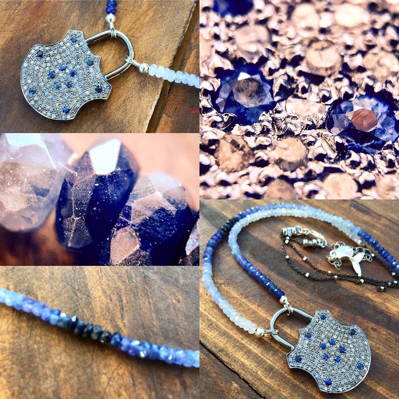 May include: A silver lock pendant necklace with a pave setting of diamonds and blue sapphires. The necklace is made with a graduated strand of blue sapphire beads.
