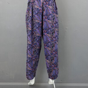 May include: Purple and pink paisley print pants with an elastic waistband.