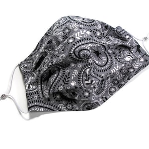 Pleated face mask in paisley print in grey, black, and white, two layer adult size mask has adjustable elastic loops and a nose wire