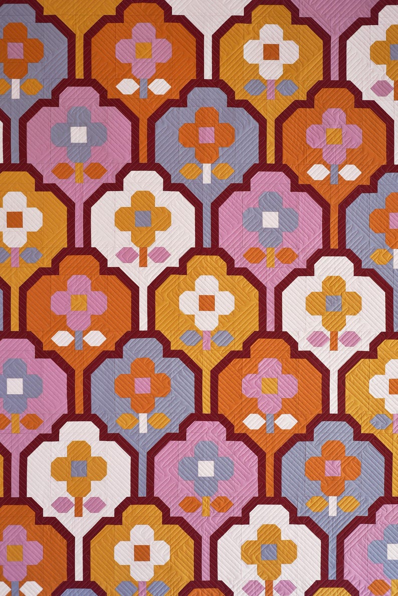 May include: A repeating pattern of stylized flowers in shades of orange, pink, white, and gray. The flowers are outlined in burgundy and have a quilted texture.