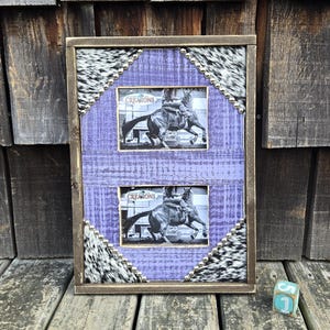 May include: A rustic, two-photo frame with a distressed wood finish. The frame features a lavender-colored center with a black and white cowhide pattern and small silver studs. Each photo displays a black and white image of a horse and rider.