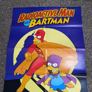 May include: A poster featuring the Simpsons characters Bart and Radioactive Man. The poster is purple with a yellow moon in the background. The text on the poster reads "Radioactive Man Meets Bartman" and "Matt Groening".