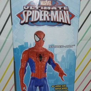 May include: A red and blue action figure of Spider-Man from the Marvel Ultimate Spider-Man series. The figure is standing on a city background. The box reads "Marvel Ultimate Spider-Man" and "Spider-Man".