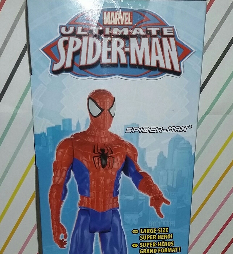 May include: A red and blue action figure of Spider-Man from the Marvel Ultimate Spider-Man series. The figure is standing on a city background. The box reads "Marvel Ultimate Spider-Man" and "Spider-Man".