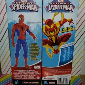 May include: Two action figures of Spider-Man in different suits. The figure on the left is in the classic red and blue suit. The figure on the right is in a red and gold suit with the text "High Tech Spider Armor!" and "Iron Spider".