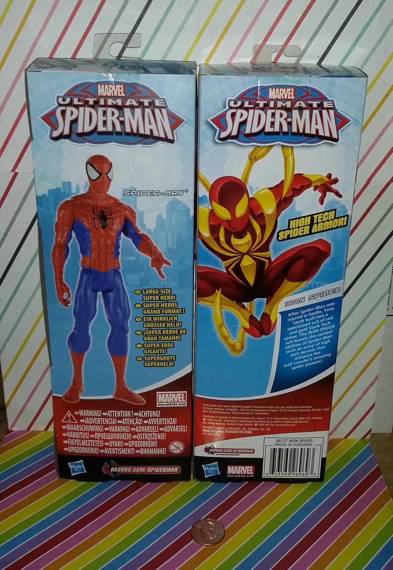 May include: Two action figures of Spider-Man in different suits. The figure on the left is in the classic red and blue suit. The figure on the right is in a red and gold suit with the text "High Tech Spider Armor!" and "Iron Spider".