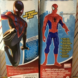 May include: Two action figures of Marvel's Spider-Man. The figure on the left is Miles Morales, wearing a red and black suit. The figure on the right is Peter Parker, wearing a red and blue suit. Both figures are posed in action poses. The boxes feature the Marvel logo and the words "Ultimate Spider-Man".
