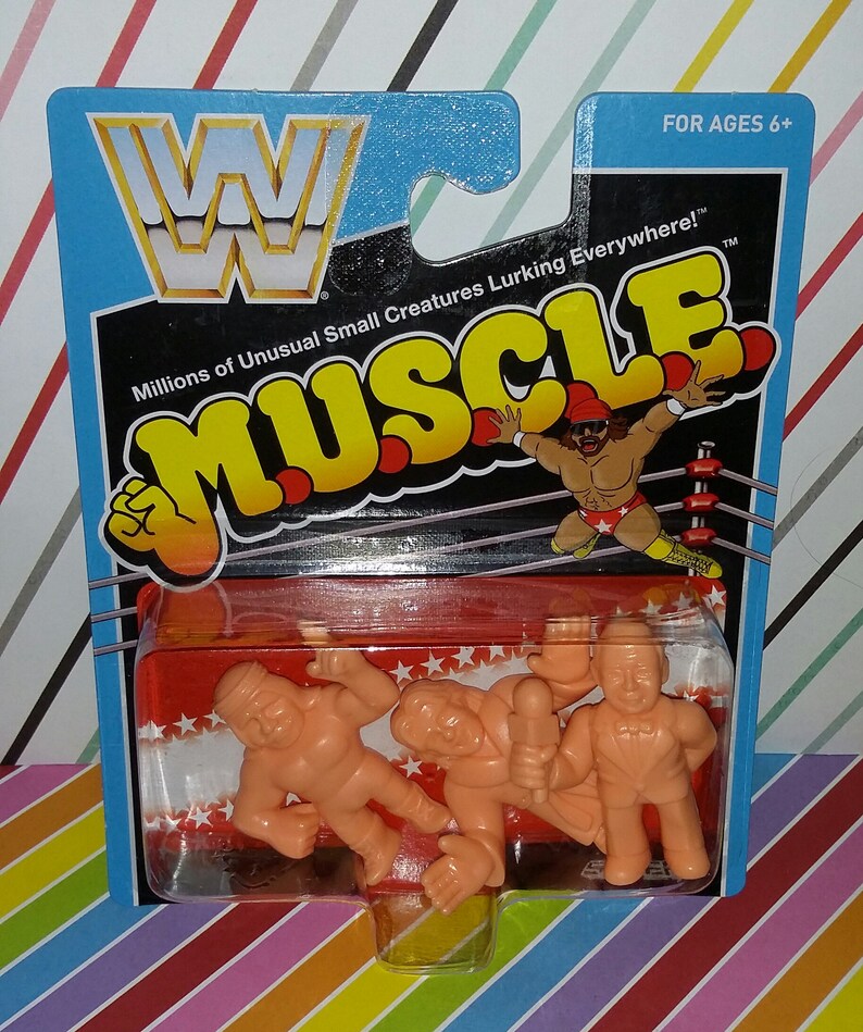 May include: A package of three small plastic figures of wrestlers. The figures are in a clear plastic blister pack on a red and white background. The package is labeled "WWF Muscle" and "Millions of Unusual Small Creatures Lurking Everywhere!" The package is for ages 6 and up.