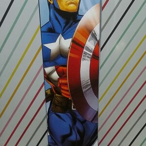 May include: A Marvel Avengers Assemble Titan Hero Series action figure box featuring Captain America. The box is blue with a comic book style illustration of Captain America holding his shield. The box also has the Marvel and Avengers logos.