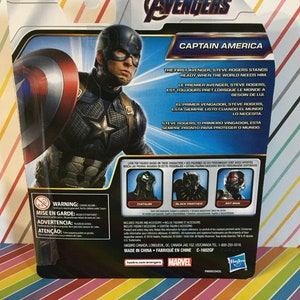 May include: Captain America action figure from the Marvel Avengers series. The figure is wearing a blue and red costume with a star on the chest. The packaging includes a quote about Captain America being ready when the world needs him. The back of the package shows other figures in the series, including Black Panther, Ant-Man, and Chitauri.