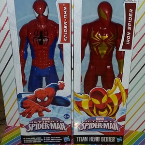 May include: Two action figures in packaging, one is red and blue Spider-Man and the other is red Iron Spider. Both figures are part of the Marvel Ultimate Spider-Man Titan Hero Series.