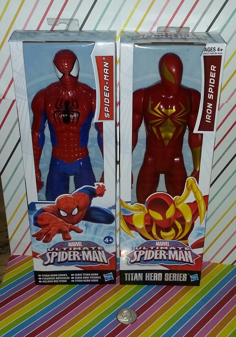 May include: Two action figures in packaging, one is red and blue Spider-Man and the other is red Iron Spider. Both figures are part of the Marvel Ultimate Spider-Man Titan Hero Series.
