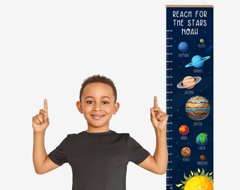 May include: A blue and black growth chart with a space theme. It features a ruler with planets and the text "Reach for the Stars Noah".