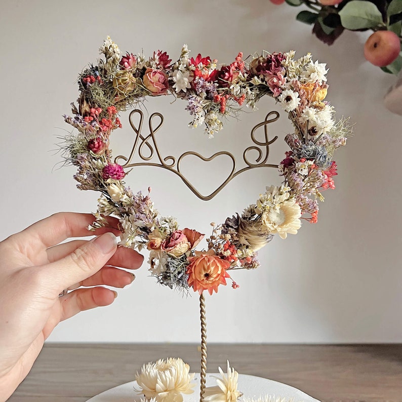 Stunning multi-coloured Dried Flower wedding or anniversary cake topper, personalised with wire initials. The topper is heart shaped and flowers and colours can be customised.