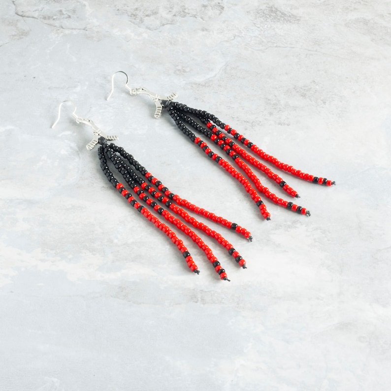 Long beaded tassels hanging from hockey charm earrings