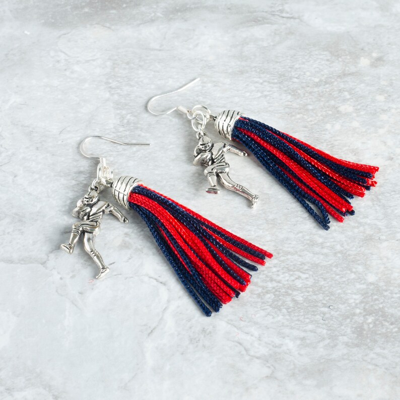 red and black tassel earrings with silver football player charms