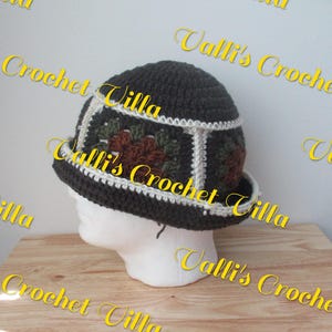 May include: A brown and white crocheted hat with a floral design. The hat has a wide brim and is made with a textured yarn.