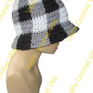 May include: A black, white, and gray crocheted bucket hat. The hat is made with a checkered pattern.