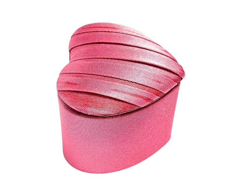 May include: A pink heart-shaped jewelry box with a satin-like finish.